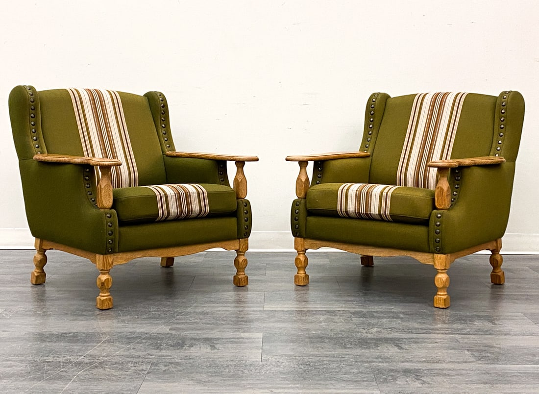 PAIR OF KJAERNULF STYLE DANISH OAK LOUNGE CHAIRS: Carved oak frame and stripe upholstery. Denmark, circa 1970s. Dimensions: H 34" x W 34" x D 33.5" x SH 15" Condition: Wear consistent with age and use. Scuffs, nicks, minor fading.