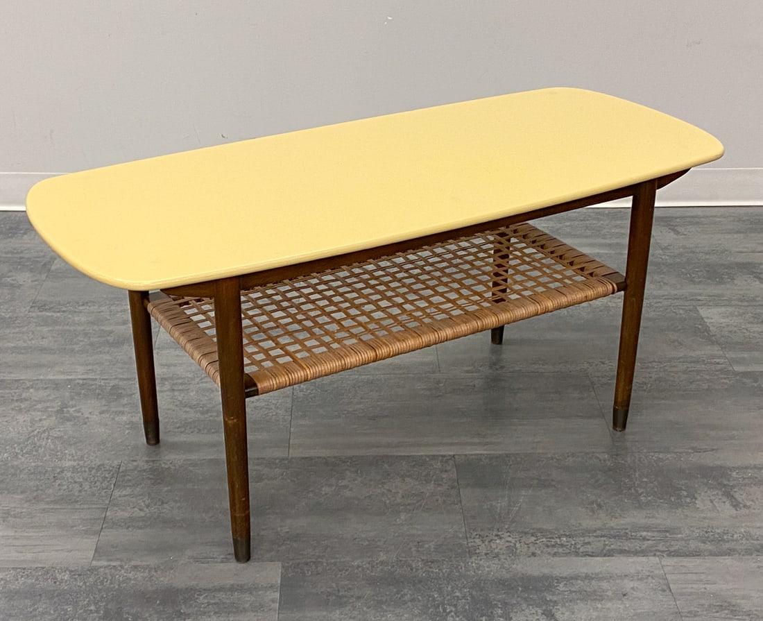 KURT OSTERVIG STYLE DANISH TEAK COFFEE TABLE 1950S: Painted top and woven rattan bottom shelf. Apparently unmarked. Painted top, Denmark, circa 1950s. Dimensions: H 21" x W 47.25" x D 19.5" Condition: Wear consistent with age and use. Scratches and rub