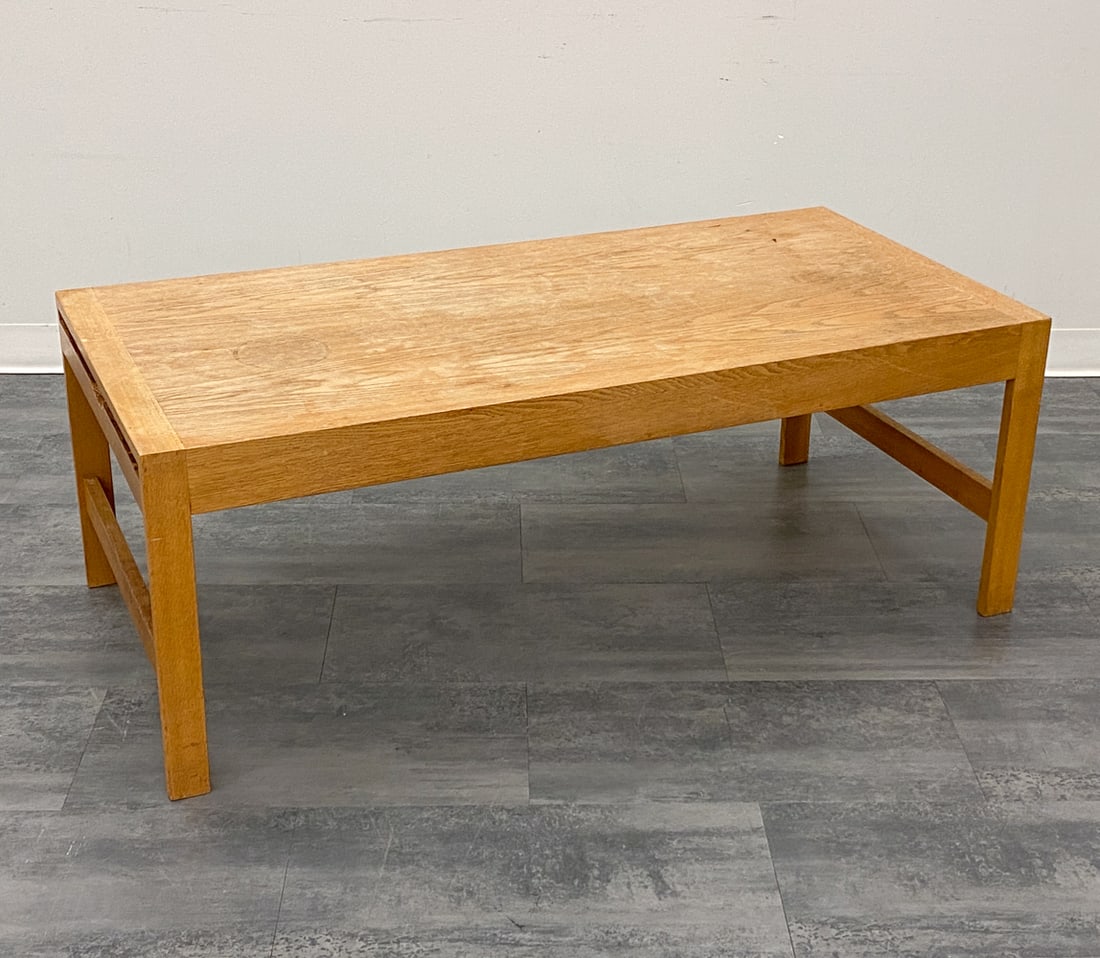 CFC SILKEBORG DANISH OAK COFFEE TABLE C. 1960S: Coffee table with two pull out black inlaid leaves and drawer for storage. Marked underneath. Denmark, circa 1960s. Dimensions: H 19.5" x W 53.25" x D 25.5" Condition: Wear consistent with age and use