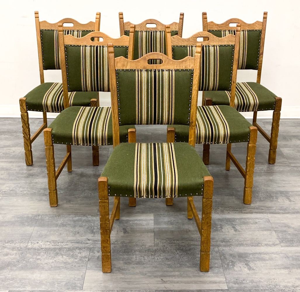 (6) STYLE OF KJAERNULF DANISH OAK DINING CHAIRS: Carved oak frame and striped upholstery. Denmark, circa 1970s. Dimensions: H 36" x W 19" x D 18" x SH 18" Condition: Wear consistent with age and use. Scuffs, fading, minor soiling, some discoloration