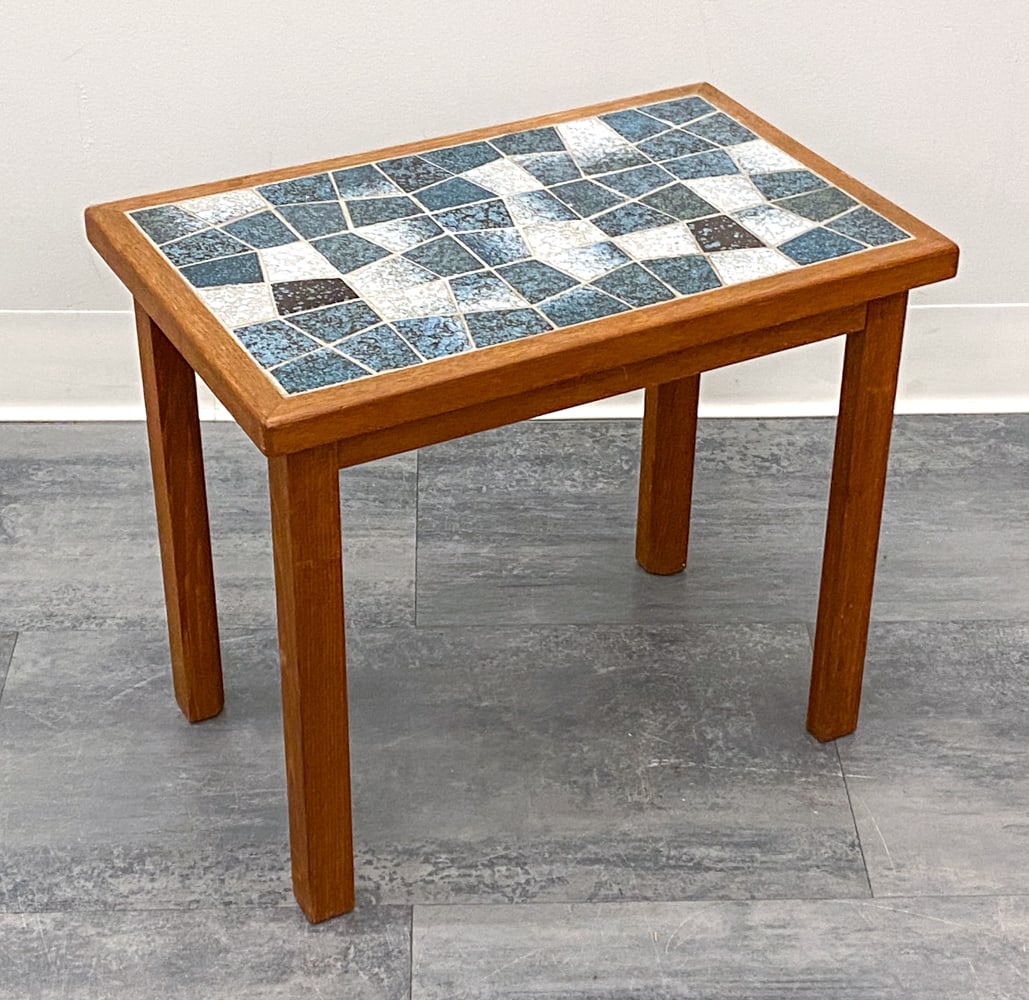 DANISH TEAK & TILE SIDE TABLE C. 1960S: Ceramic tile top and teak frame. Denmark, circa 1960s. Dimensions: H 16" x W 18.5" x D 12" Condition: Wear consistent with age and use. Fading, watermarks, scuffs.
