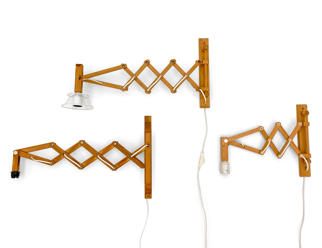 LE KLINT STYLE PINE EXTENDING SCISSOR WALL SCONCES: (3) scissor-arm wall sconces. In pine. Denmark, circa 1960s. Dimensions: H 12" x W 20" x D 2" Condition: Wear consistent with age and use. Wiring untested, cord cut. Scuffs, rubs, fading, watermarks.