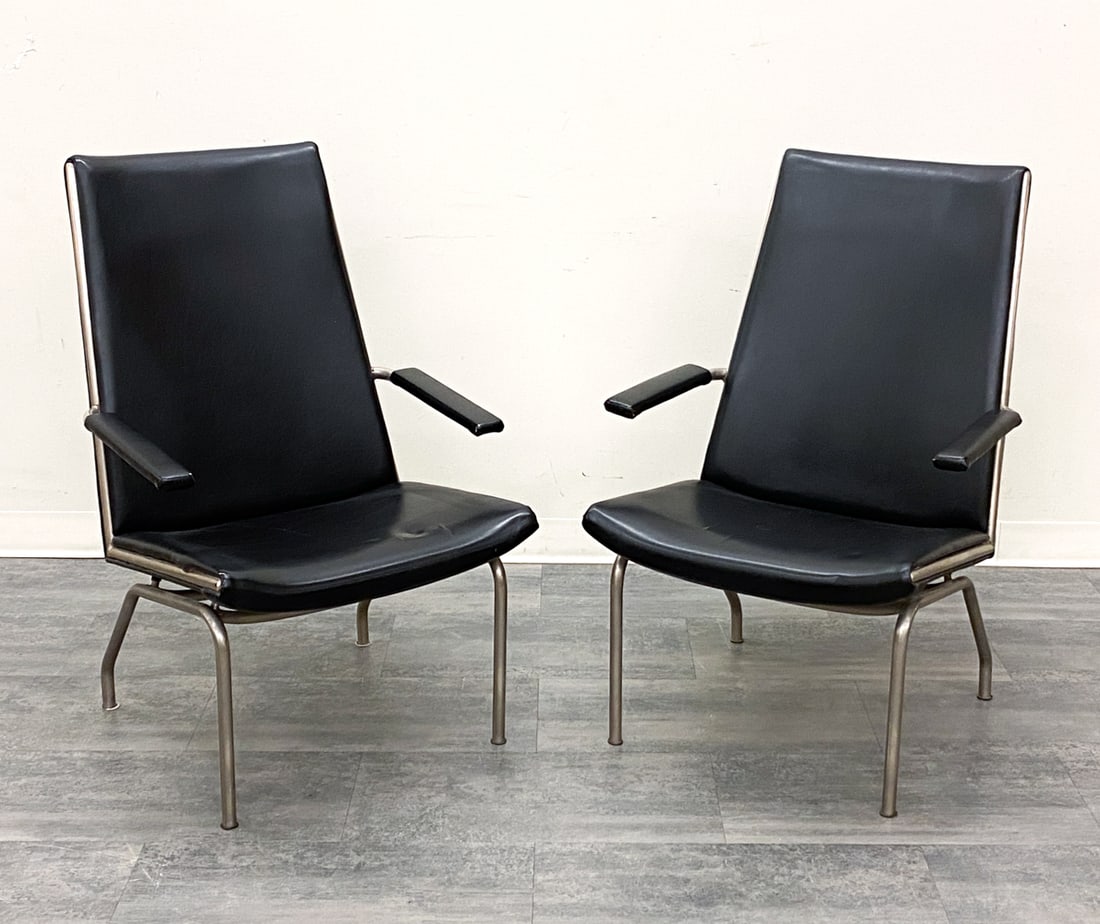 PAIR OF GISPEN STYLE SCANDINAVIAN LOUNGE CHAIRS: Black faux leather upholstery and steel frame. Scandinavian, 20th century. Dimensions: H 39.25" x W 24.5" x D 28" x SH 17" Condition: Wear consistent with age and use. Distress, tear and indentation