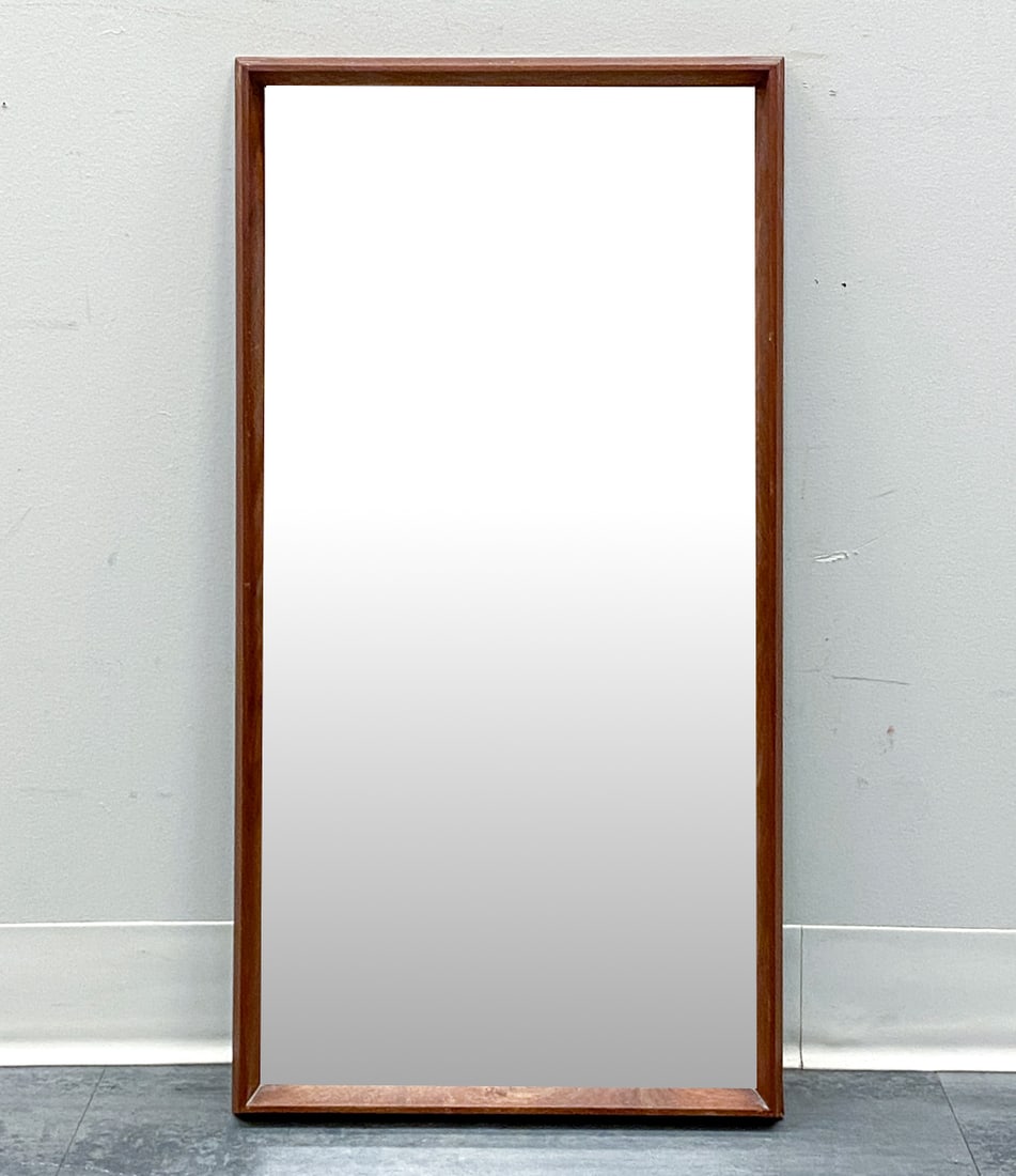 JANSEN SPEJLE DANISH TEAK WALL MIRROR C. 1960S: Dimensions: H 29.25" x W 15.25" Condition: Wear consistent with age and use. Minor watermarks, scuffs to frame. Ding to top left corner.