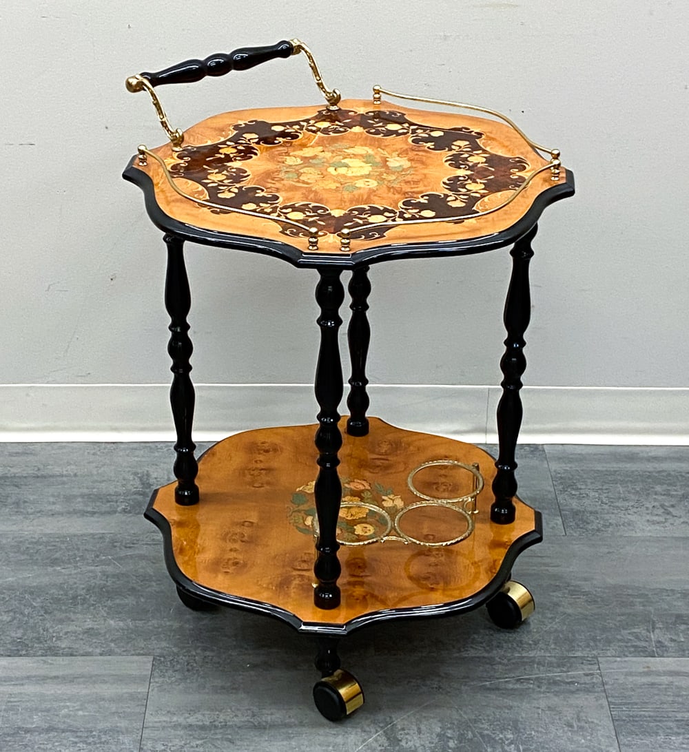 ITALIAN WALNUT MARQUETRY BAR CART C. 1960S: Features scalloped-edge marquetry on a walnut ground with gloss lacquer finish and casters. Italy, circa 1960s. Dimensions: H 29.5" x Dia 21" Condition: Wear consistent with age and use. Soiling,