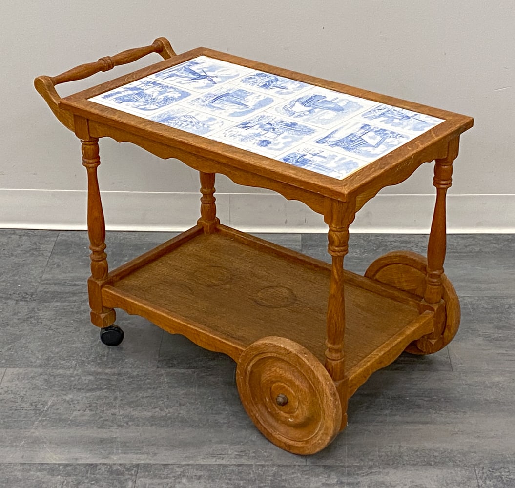 KJAERNULF STYLE DANISH OAK & TILE BAR CART 1960S: Danish serving cart with tile top and carved oak frame. Denmark, circa 1960s. Dimensions: H 22" x W 33" x D 16.25" Condition: Wear consistent with age and use. Discoloration, scuffs, watermarks, some