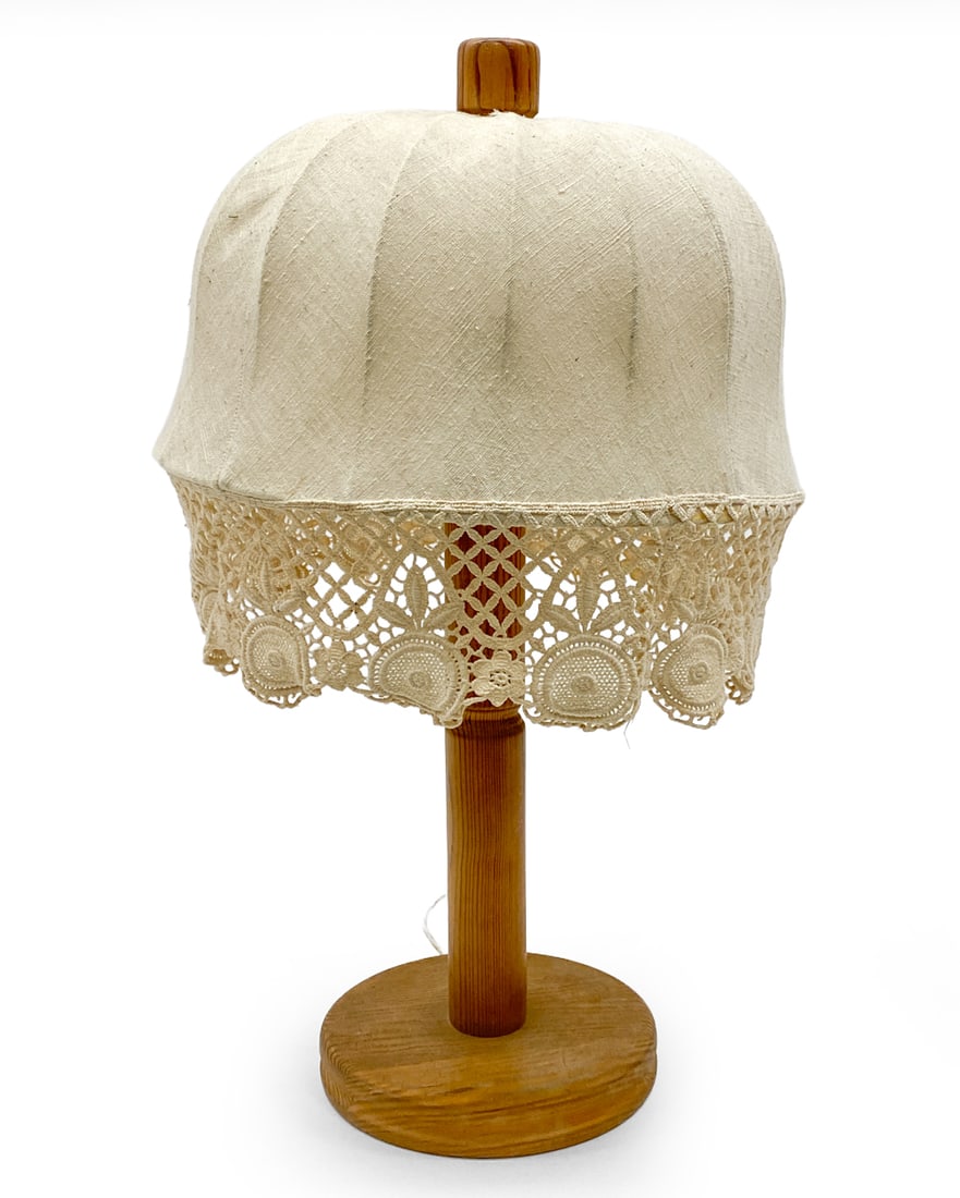 STYLE OF YNGVE EKSTROM SWEDISH PINE TABLE LAMP: Pine lamp with beige tone shade. Apparently unmarked. Sweden, circa 1960s. Dimensions: H 23.5" x Dia 13" Condition: Wear consistent with age and use. Wiring untested, cord cut. Discoloration to base,