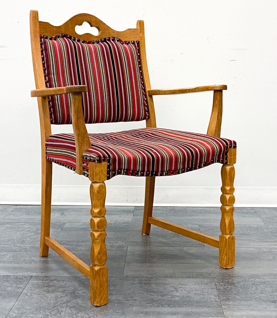 STYLE OF KJAERNULF DANISH OAK ARMCHAIR C. 1970S: Carved oak frame and striped upholstery. Denmark, circa 1970s. Dimensions: H 36" x W 25" x D 23" x SH 18" Condition: Wear consistent with age and use. Scuffs to frame. Some fading and discoloration.