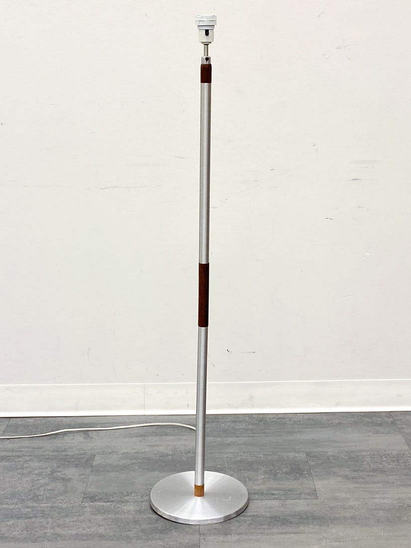 SCANDINAVIAN TEAK & ALUMINUM FLOOR LAMP C. 1960S: Aluminum floor lamp with teak accents. Scandinavian, circa 1960s. Dimensions: H 47.5" x Dia 10" Condition: Wear consistent with age and use. Scuffs. Wiring untested, cord cut. Couple of dents to base.