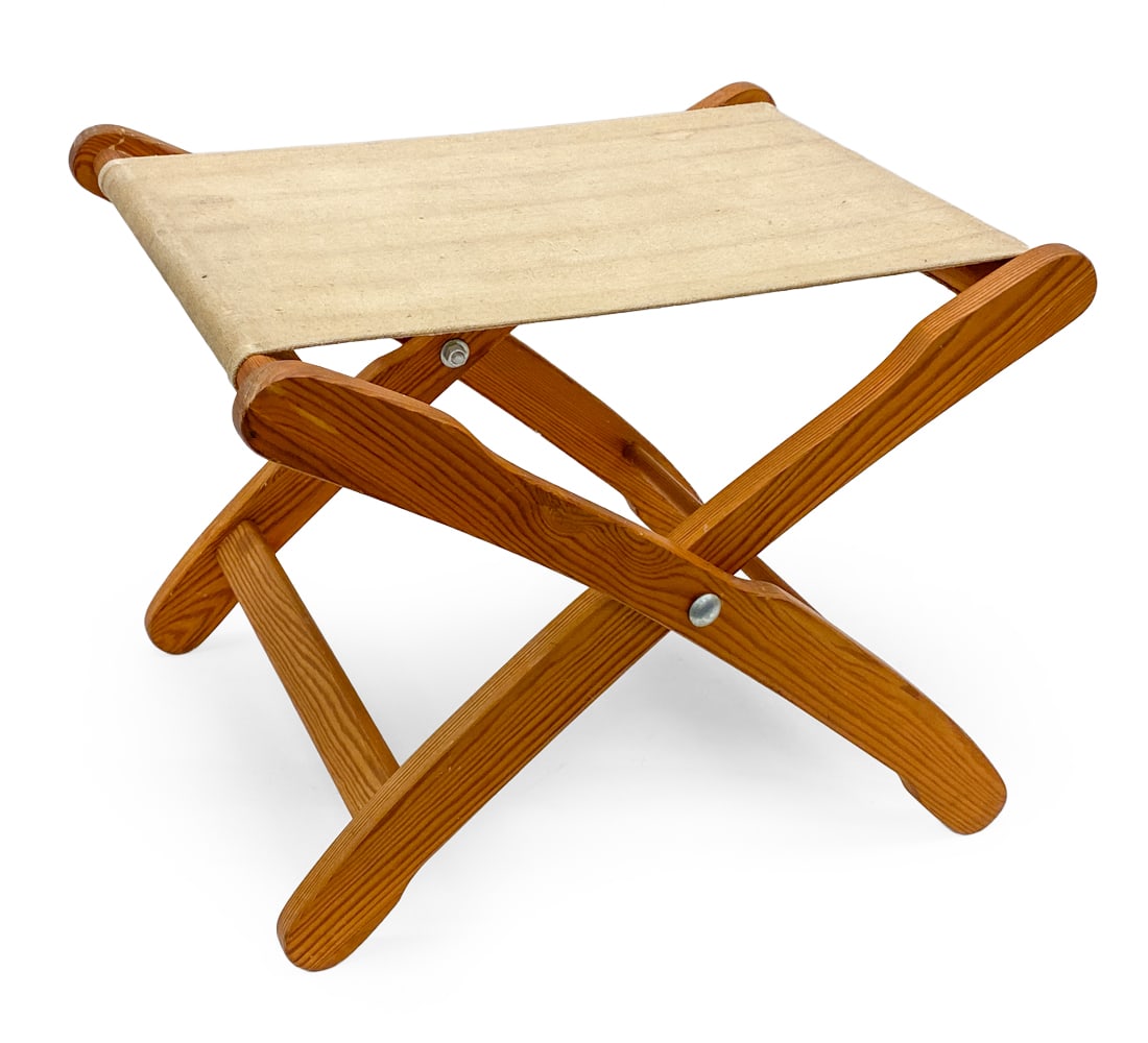 SCANDINAVIAN PINE FOLDING STOOL: Pine frame and canvas sling seat. Scandinavian, 20th century. Dimensions: H 15.5" x W 20" x D 15.5" Condition: Wear consistent with age and use. Soiling, watermarks, discoloration, nicks, rubs.