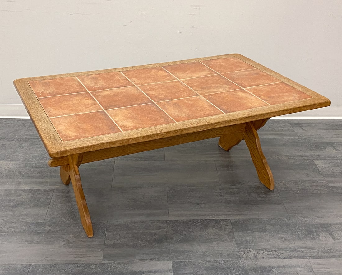 SCANDINAVIAN OAK & TILE COFFEE TABLE C. 1970S: Tile top and trestle base coffee table. In oak. Denmark, circa 1970s. Dimensions: H 22" x W 54.5" x D 35" Condition: Wear consistent with age and use. Scuffs, discoloration spots, soiling, some