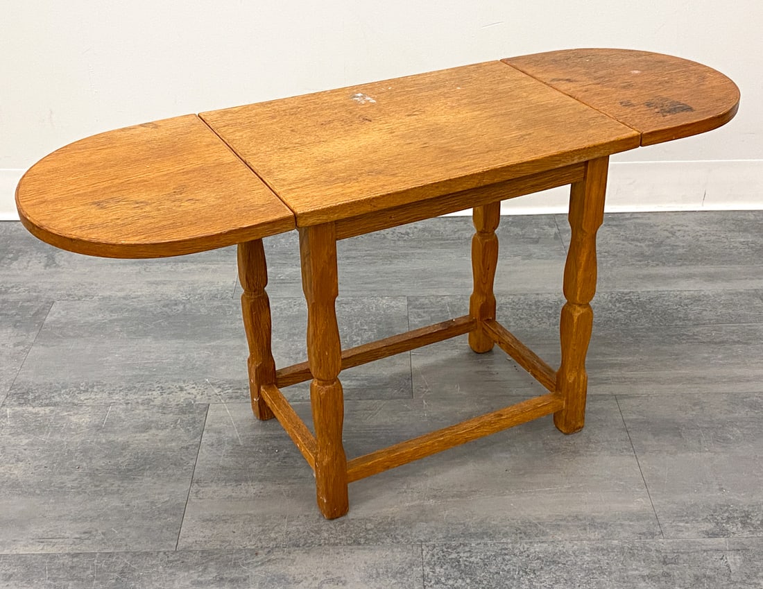 KJAERNULF STYLE DANISH OAK SIDE TABLE C. 1970S: Features two drop leaves for extension. Denmark, circa 1970s. Dimensions: H 18" x W 17.75" x D 12.75" (Leaf) 9.75" Condition: Wear consistent with age and use. Scuffs, fading, discoloration. soiling
