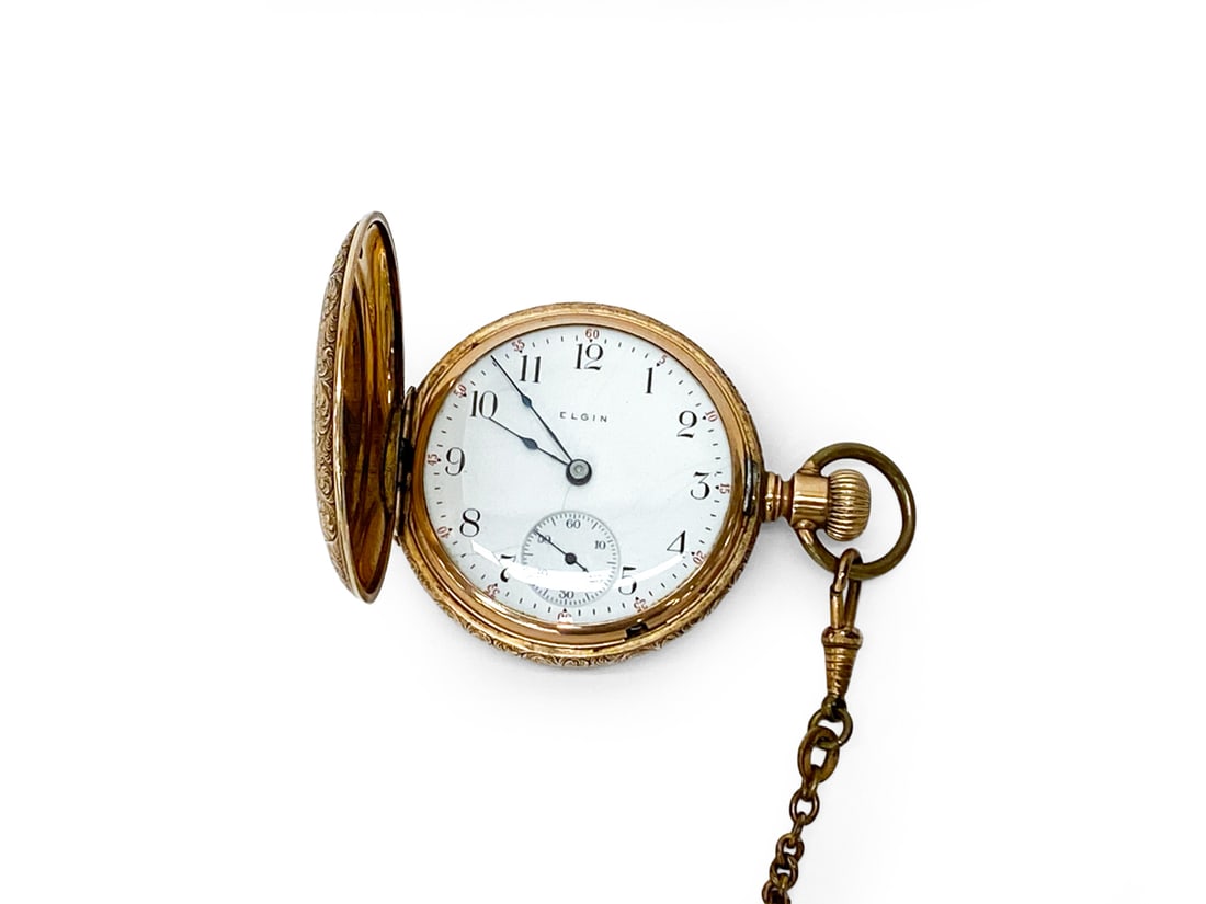 ANTIQUE ELGIN GOLD FILLED HUNTER CASE POCKET WATCH: Marked to dial. Featuring intricate floral scene engravings on the gold-filled case. Early 20th century. Dimensions: H 2.25" x W 2" Condition: Wear consistent with age and use. Time keeping untested. 