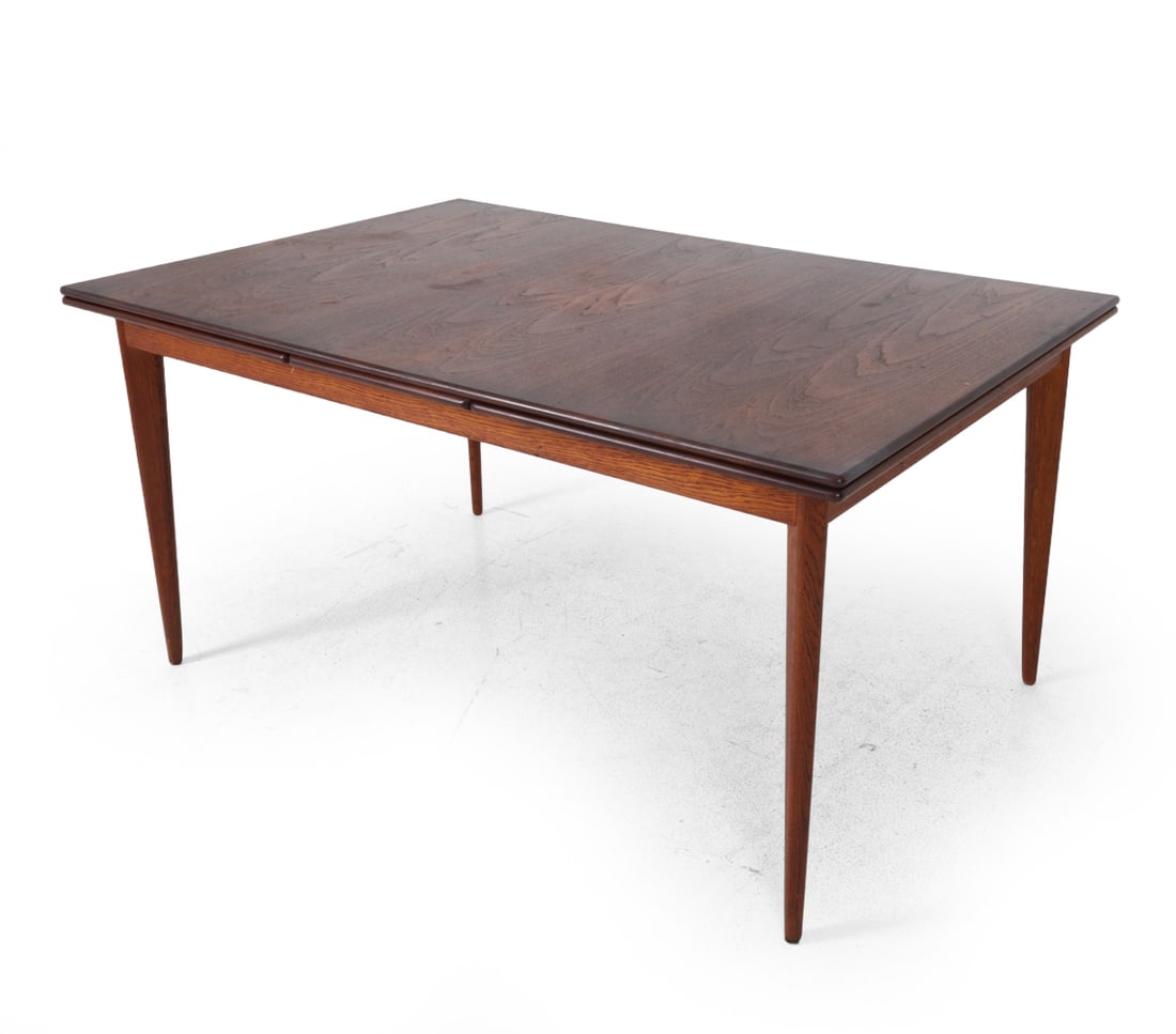 DUX SWEDISH TEAK EXTENDING DINING TABLE C. 1960S: Teak with tapered legs and two extending leaves. Marked DUX underneath. Sweden, circa 1960s. Dimensions: H 29.5' 'x W 59''x D 40'' (each leaf) W 22.5" Condition: Discoloration and water stains on top,