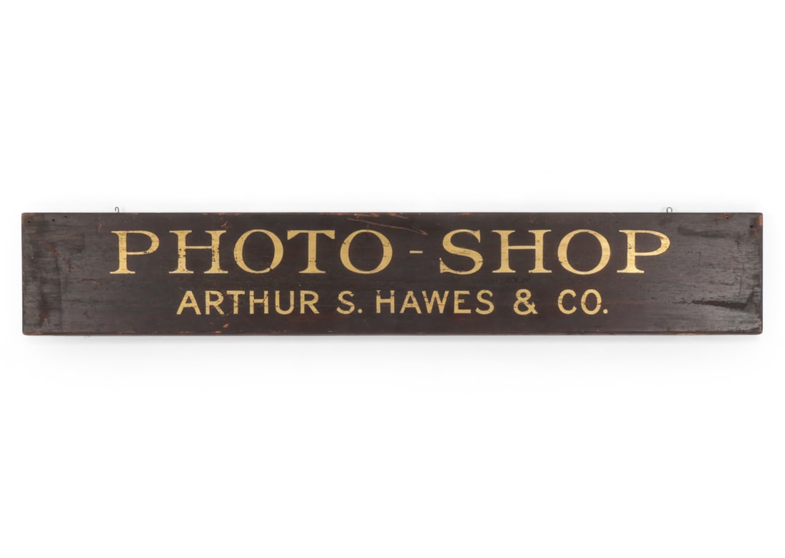 ANTIQUE ARTHUR S. HAWES PHOTO SHOP TRADE SIGN: Hand painted and gilt lettered wooden trade sign for Arthur S. Hawes & Co., reading "PHOTO-SHOP/ ARTHUR S. HAWES & CO." on a black ground. American, Late 19th/Early 20th century. Dimensions: H 8.25 " 