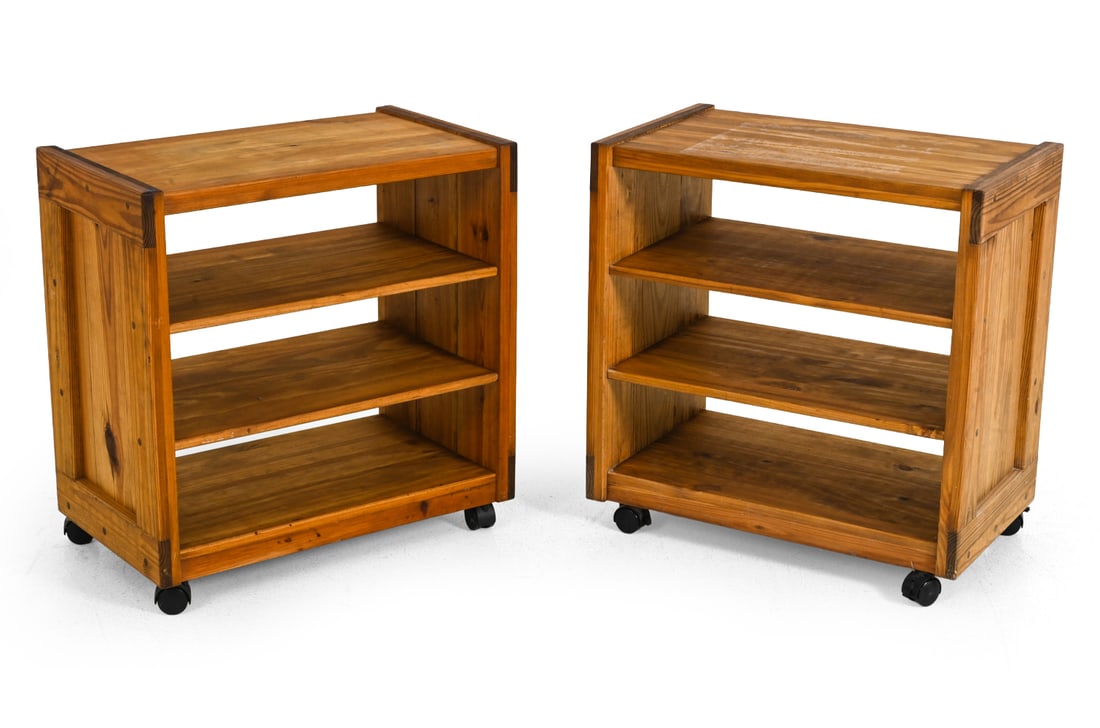 PAIR OF BRUTALIST PINE ROLLING SHELVES: Pine with 3-tiered shelves and wheels. 1970s. Dimensions: H 29'' x W 28'' x D 16.5'' Condition: Discoloration, faded, soiling, and minor cracks. Wear consistent with age and use.