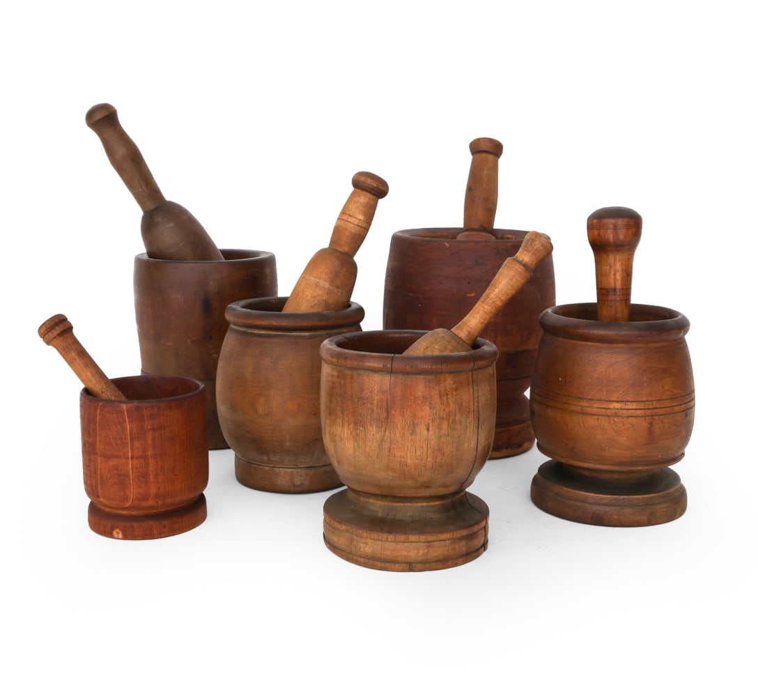 GROUPING OF WOODEN MORTAR AND PESTLES: (5) wood mortar and pestle sets. Varying ages and styles. Dimensions H 15 " x W 7" D 7" Wear and cracks, chips to wood to some pestles cracked, Wear consistent with age and use.