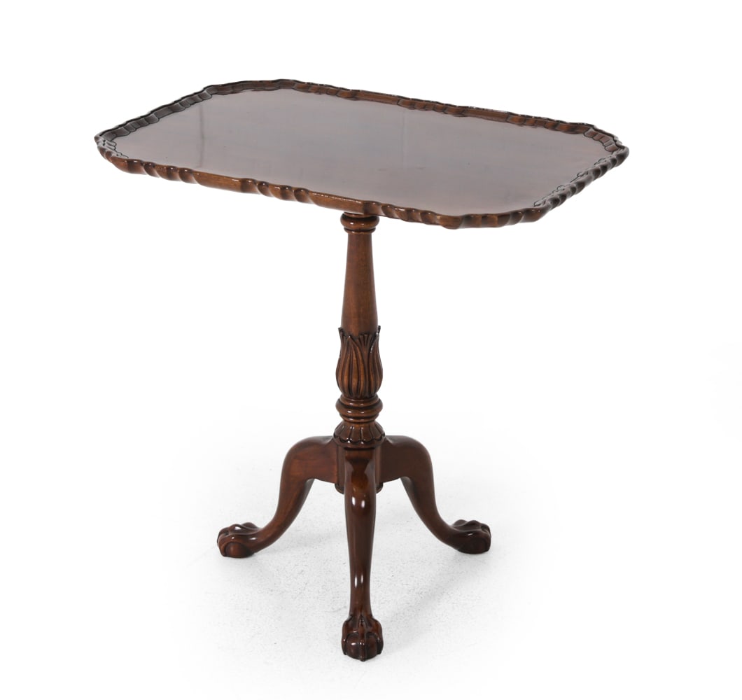 CHIPPENDALE STYLE MAHOGANY FLIP TOP TABLE: Mahogany with scalloped edge top, a carved pedestal column, and ball and claw feet. 20th century. Dimensions: H 26.75''x W 26.25''x D18'' Condition: Dings, scuffs, and scratches. Wear consistent to ag