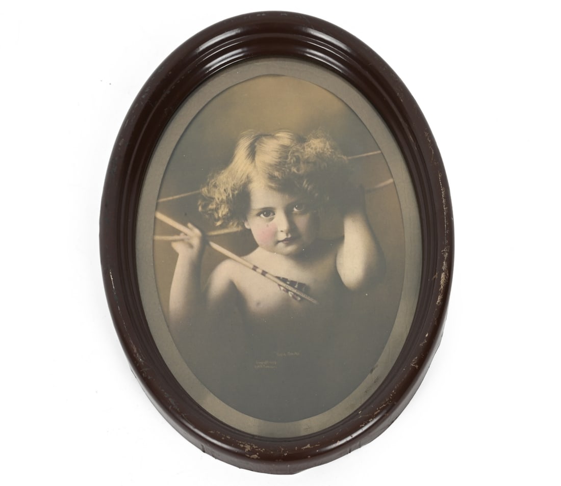 PARKINSON (1847-1926) CUPID AWAKE PRINT: "Cupid Awake" by M. B. Parkinson in steel oval frame. Circa. 1897. Dimensions: H 14.5'' x W 11.5" Condition: Paint loss to frame. Wear consistent with age and use.