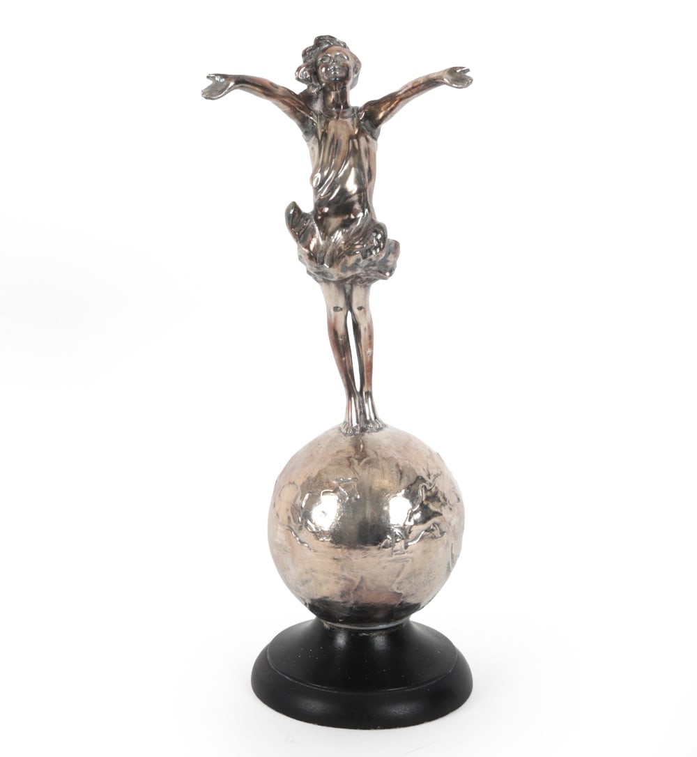 JESSIE MCCUTCHEON "GOOD FAIRY" SCULPTURE: "Good Fairy" standing on top of chrome globe with black finished wooden base. Marked to bottom of globe. Circa 1927. Dimensions: H 16.25" x W 5.75" Condition: Scuffs, wear of finish at base, and patin