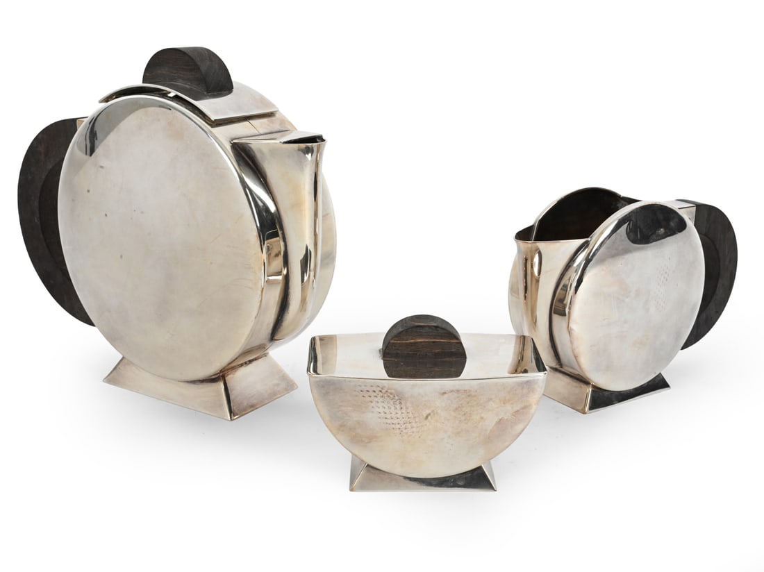 CHRISTOFLE "TONNELET" SILVERPLATE TEA SET C. 1930S: Christian Fjerdingstad for Christofle "Tonnelet" silver plated Art Deco tea set with wood handles. Marked underneath. France, circa 1930s. Provenance: Originally purchased at T. J. Antorino Antiques a