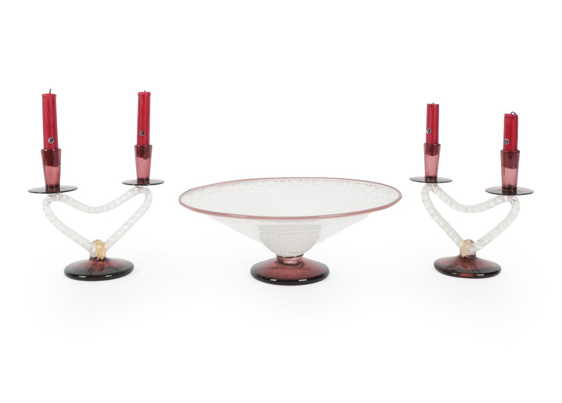 MID-CENTURY MURANO GLASS CANDLE HOLDER & COMPOTE: Pair of red and white candelabras with matching centerpiece bowl. Dimensions: (Candleholder without candle) H 8" x W 9" x D 4.25", (Bowl) H 5" x W 3.5" x D 3.5" Condition: Wax, chips and scratches on 