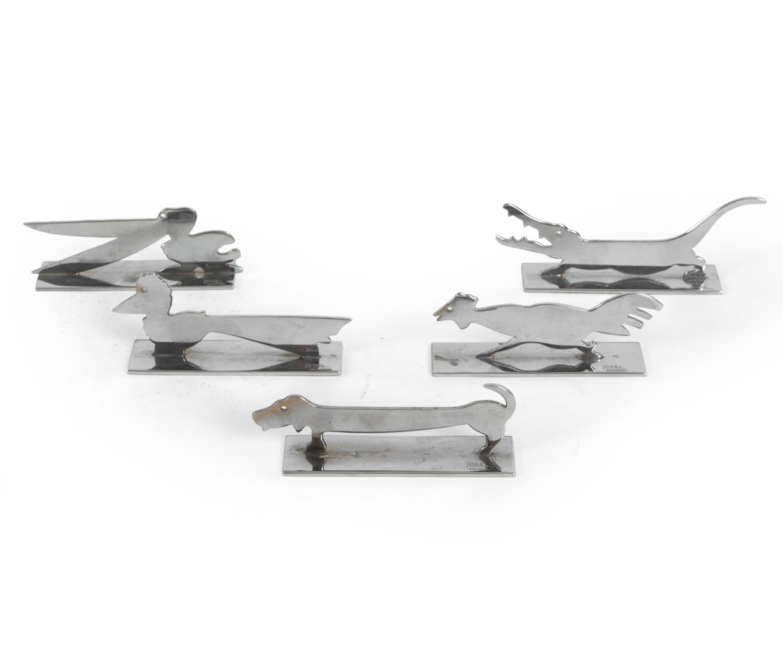 YOREL FRENCH ART DECO CHROME KNIFE RESTS C. 1930S: (5) Total. Includes alligator, pelican, dachsund, rooster, and bird. "Yorel" marked on bases. Chrome plated brass. Dimensions: (Largest) H 1.5" x W 4.25" x D 1" Condition: Losses, scratches and oxidat
