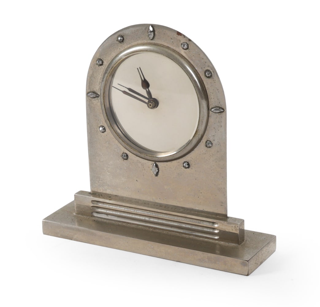 ART DECO MANTEL CLOCK: Art deco mantel clock, likely in nickel-plated metal. Apparently unmarked. Circa 1930s. Dimensions: H 4" x W 4" x D 1" Condition: Wear consistent with age and use, including some patina and scratches.