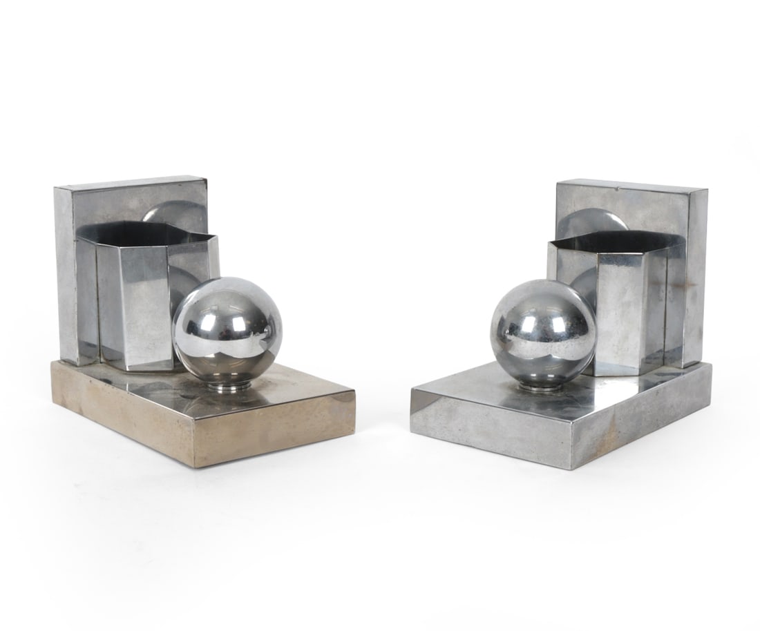 ART DECO CHROME ARCHITECTURAL BOOKENDS: Chrome plated brass geometric bookends Circa 1930s Dimensions: H 4.5" x W 3.5" x D 5.5" Condition: Tarnish and loss to chrome. Wear consistent with age and use.