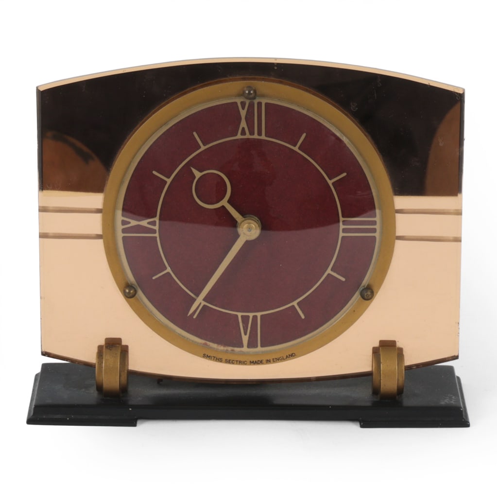 SMITH SECTRIC ENGLISH ART DECO MIRRORED CLOCK: Smith Sectric mirrored clock. Made in England. Marked on clock face. European plug. Dimensions: H 7" x W 8" x D 3.5" Condition: Scratches and watermarks to mirrored surface. Oxidation to metal. Loss t
