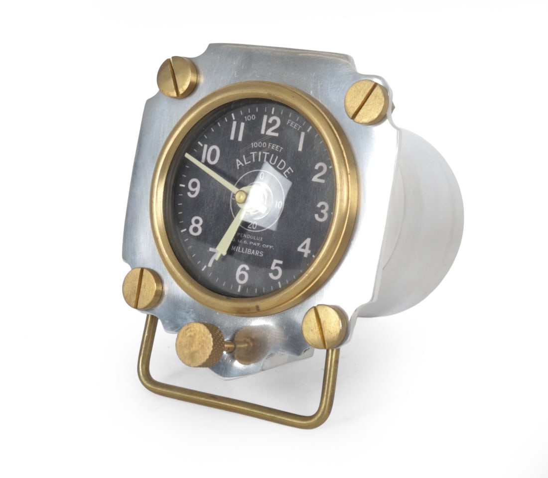 PENDULUX ALTIMETER AVIATION STYLE AIRPLANE CLOCK: Pendulux altimeter table clock patterned after a 1939 Army Air Corps altimeter. Cast aluminum body with solid brass hardware and black aviation style dial and millibars markings. Dimensions: H 5.5" x 
