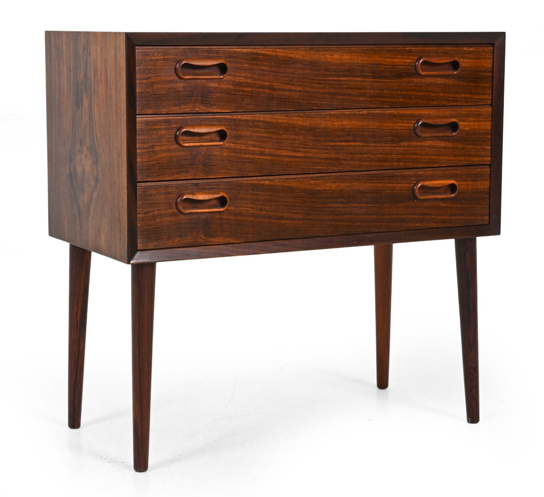 DANISH ROSEWOOD SMALL CHEST OF DRAWERS C. 1960S: Rosewood with tapered legs, three drawers, and recessed drawer pulls. Denmark, circa 1960s. Dimensions: H 23.5'' x W 24'' x D 12" Condition: Light surface wear consistent with age and use. JE065
