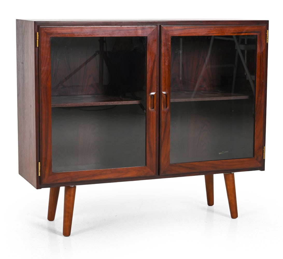DANISH ROSEWOOD & GLASS DISPLAY CABINET C. 1960S: Rosewood display cabinet with glass door. Marked to backside. Denmark. circa 1960s. Dimensions: 33.5" x W 39.5" x D 12" Condition: Scuffs and scratches to surface. Wear consistent with age and use. JE