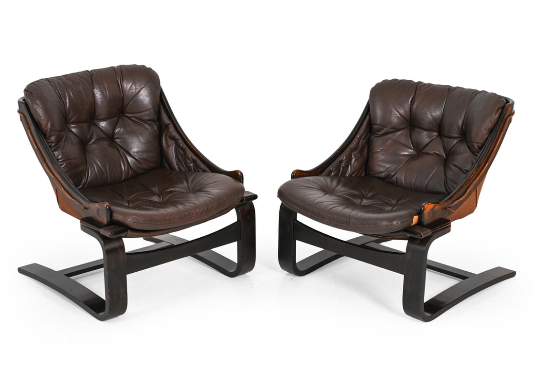 PAIR AKE FRIBYTER LEATHER LOUNGE CHAIRS C. 1970S: Tufted leather upholstery with stained beech frame. Scandinavia, circa 1970s. Dimensions: H 30.75'' x W 26'' x D 27'' x SH 15.5'' Condition: Discoloration. Minor scratches. Some scuffs. Wear consisten