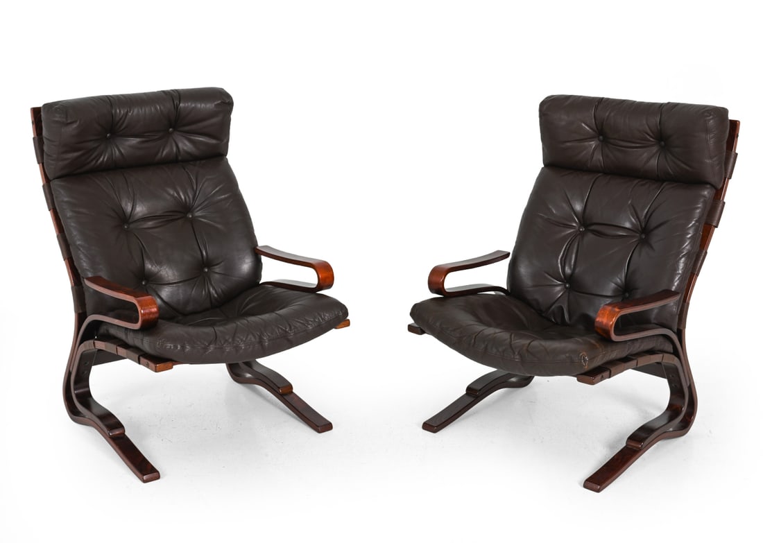 ELSA NORDAHL SOLHEIM LEATHER LOUNGE CHAIRS C 1970S: Pair of leather and beech easy chairs designed by Elsa Nordahl "Skyline" model. Scandinavian. Circa 1970s. Cushions button to frame. Dimensions: H 39.5" x W 25" x D 22.5" x SH 16.75" Condition: Scratc