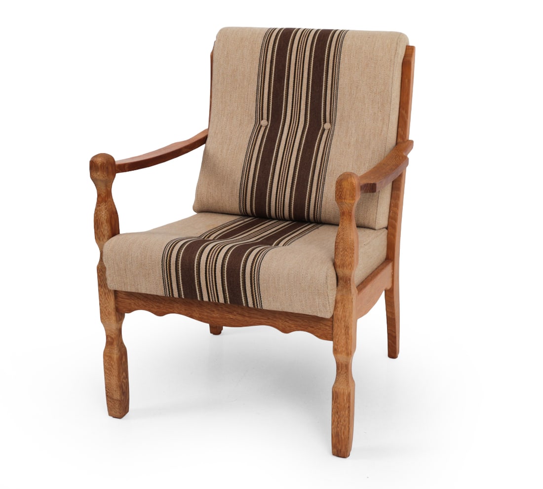 DANISH BRUTALIST OAK EASY CHAIR C. 1970S: Brutalist oak easy chair with striped upholstery. Danish. Circa 1970s. Dimensions: H 35.5" x W 25.5" x D 29? x SH 18.5? Condition: Staining and discoloration to upholstery. Scuffs to wood. Wear consis