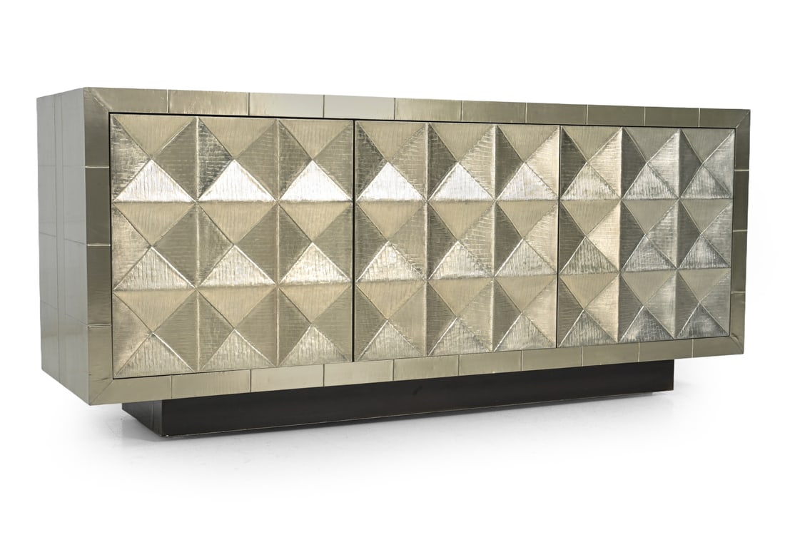 JONATHAN ADLER "TALITHA" METALLIC SIDEBOARD: Marked to inside. Clad with nickel-plated metal, Hand stamped in geometric pattern . Interior is finish with blue paint. Dimensions: H 30.75''x W 70.25''x D 20.25'' Condition: Scuffs, discoloration.