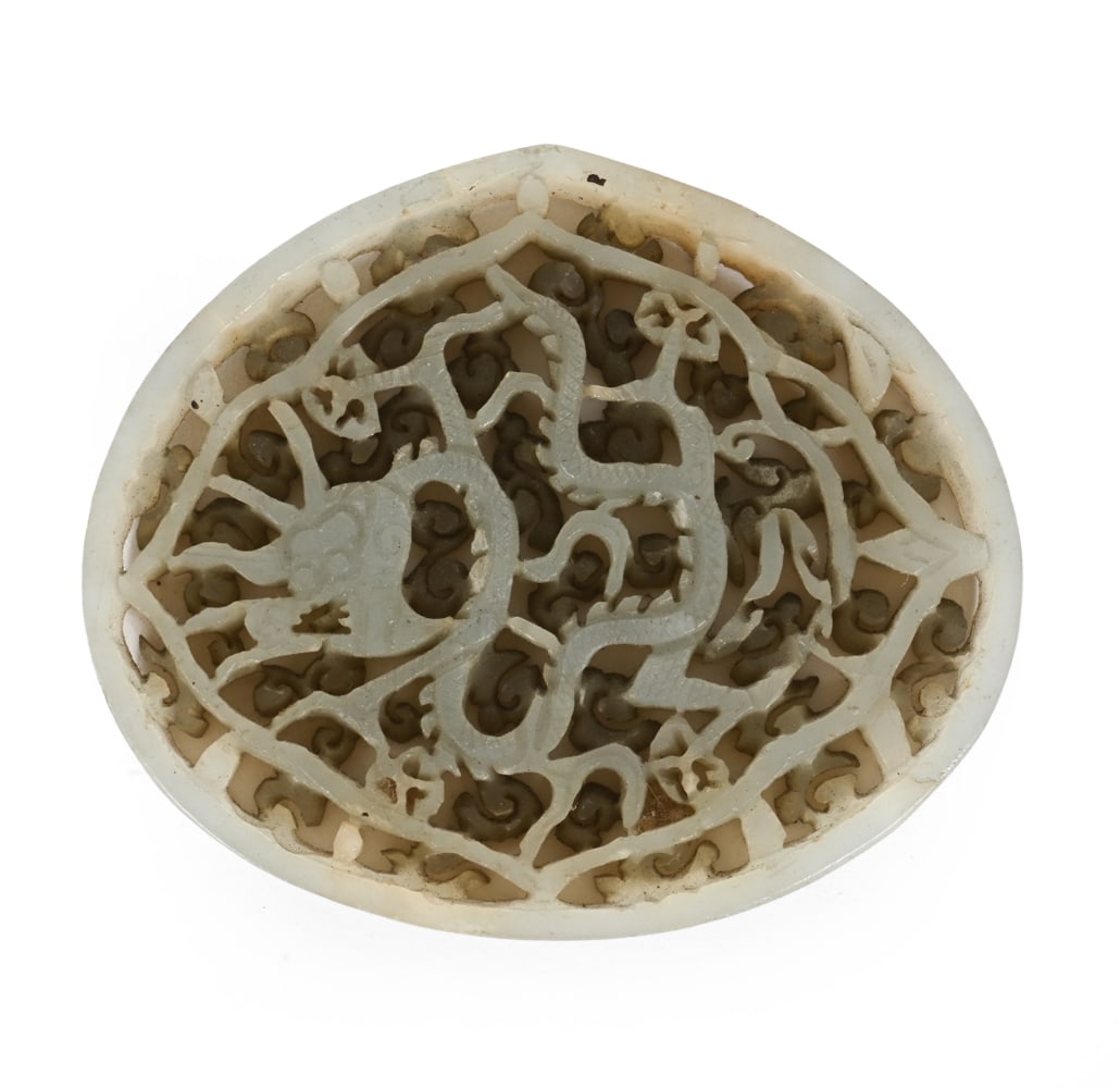 CHINESE CARVED HARDSTONE JADE PLAQUE: Chinese carved circular plaque openwork decoration of scrolling and stylized motifs. Dimensions: H 2" x W 2.5" Condition: Wear consistent with age.
