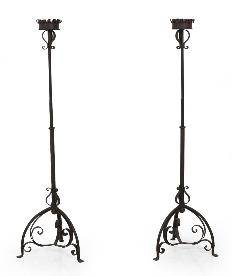 PAIR OF SPANISH REVIVAL STYLE IRON CANDLE STANDS: Intentionally distressed bent iron candle stands. Mid 20th century. Dimensions: H 55.25''x W 16.5''x D 15.5'' Condition: Heavy patina and surface wear. Wear consistent with age and use.