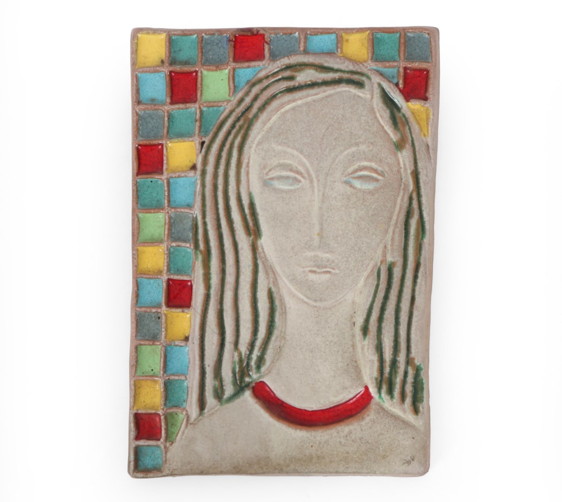 HARRIS G. STRONG CERAMIC WALL PLAQUE: Harris G. Strong mid century glazed ceramic wall plaque depicting a stylized female portrait with multicolor geometric tile decoration. Unsigned. Dimensions: H 14" x W 9.5" Condition: Showing signs of