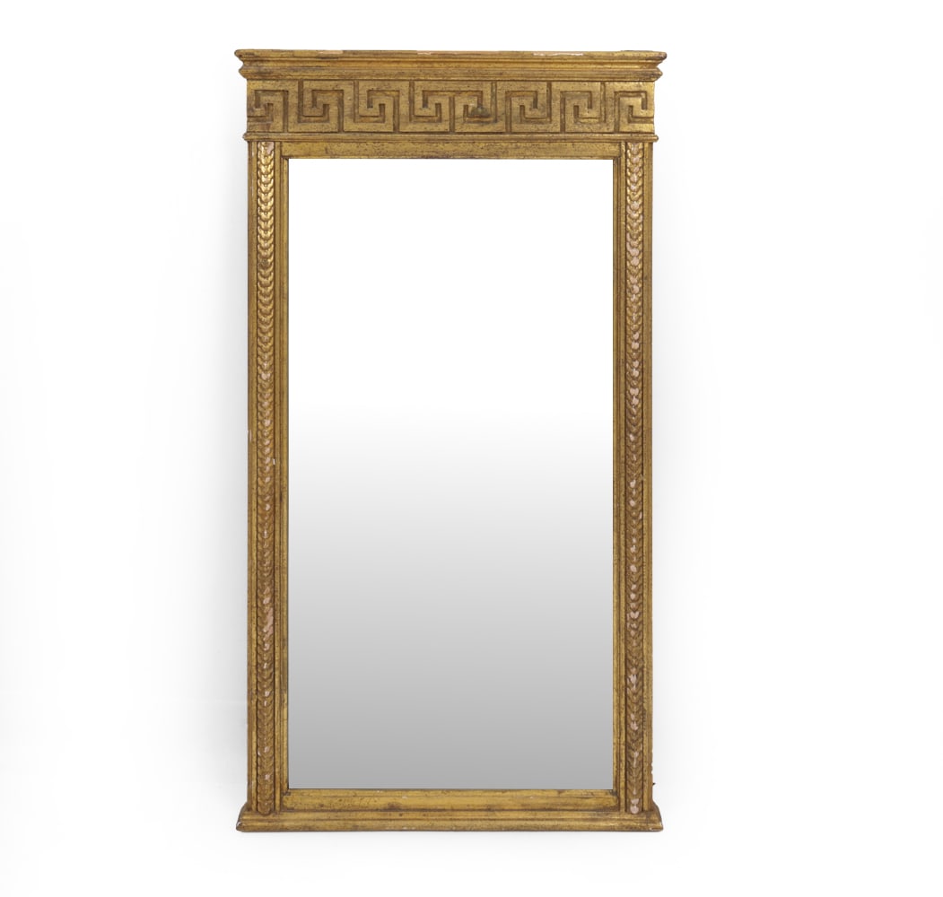 ITALIAN CLASSICAL GILTWOOD MIRROR: Italian giltwood mirror with classical key frieze and carved leaf borders. Stamped "Made in Italy" on verso. 20th century. Dimensions: H 41.5" x W 22.5" x D 1.75" Condition: Showing signs of wear incl