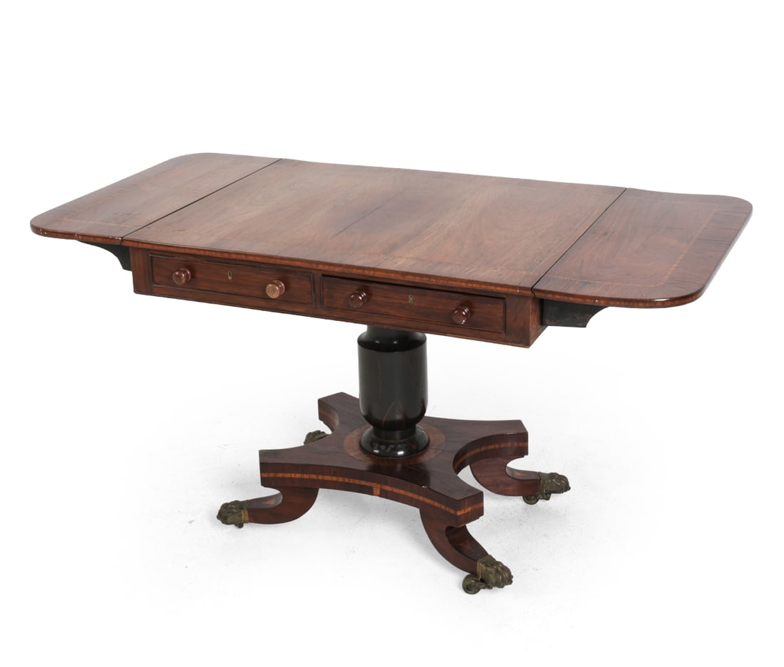 REGENCY-STYLE MAHOGANY DROP-LEAF SOFA TABLE: Mahogany with inlaid border, two drop leaves, two drawers, and lion's feet casters. No key included. Left drawer isn't functional. Late 19th-early 20th century. Dimensions: H 27.75" x (without leaves)
