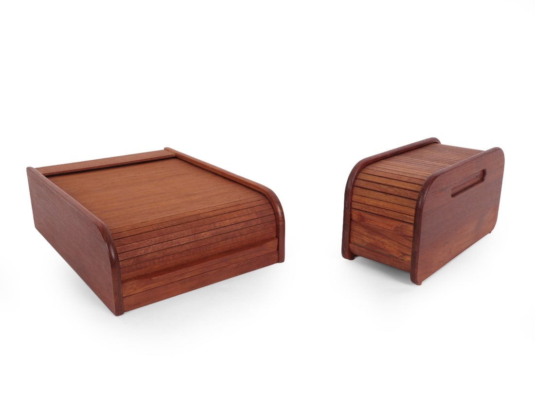 MID-CENTURY TEAK TAMBOUR ORGANIZER BOXES: (2) teak tambour roll top storage boxes in curved frame. Marked "EIN" and "Selandia Designs" to underside. Circa 1960s. Dimensions:(Largest) H 4.5 " x W 10.25" x D 14.25" Condition: Scratches and
