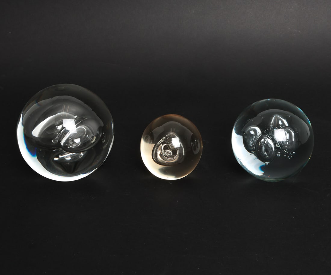 (3) MURANO GLASS PAPERWEIGHT GROUPING: Clear glass with included bubbles. Circa 20th century. Smallest labeled underneath. Dimensions: (largest) Dia. 5" Condition: Light surface scuffs to bases. Wear consistent with age and use.