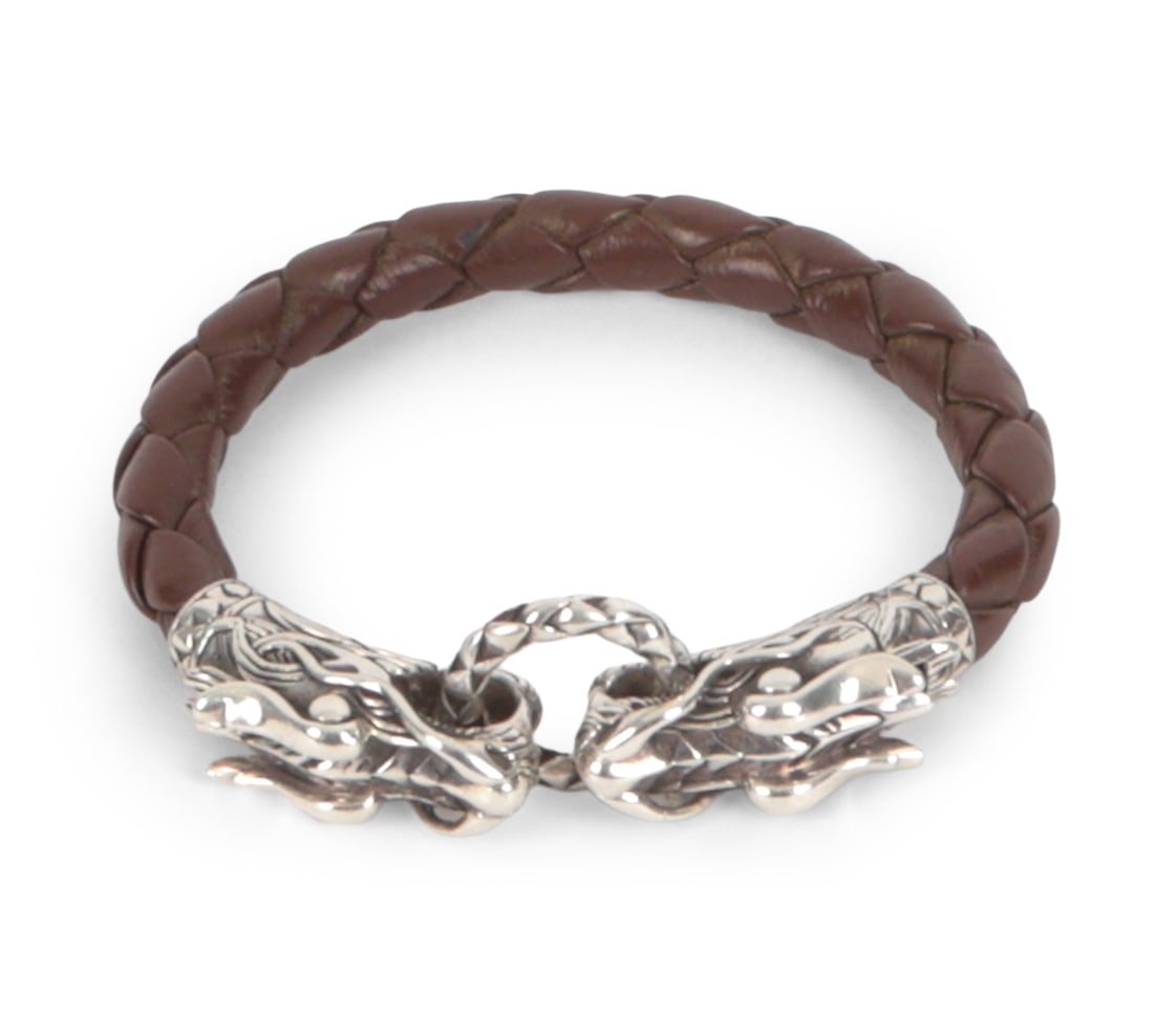 JOHN HARDY LEGENDS STERLING & LEATHER BRACELET: Naga double dragon sterling clasp with a woven leather band. 925 stamped on clasp. Dimensions: L 7.75 " Condition: Light surface wear and scuffs. Wear consistent with age and use.