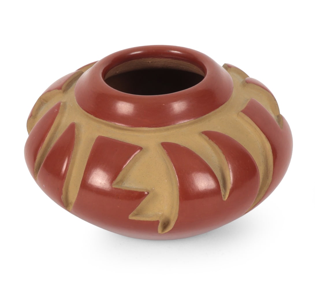 ANITA L. SUAZO PUEBLO REDWARE POTTERY C. 1970S: Santa Clara Pueblo carved redware pottery vessel by Anita Louise Suazo with geometric decoration. Signed to underside. Dimensions: H 3.5 " x W 5.5" Condition: Minor surface scratches and scuffs.