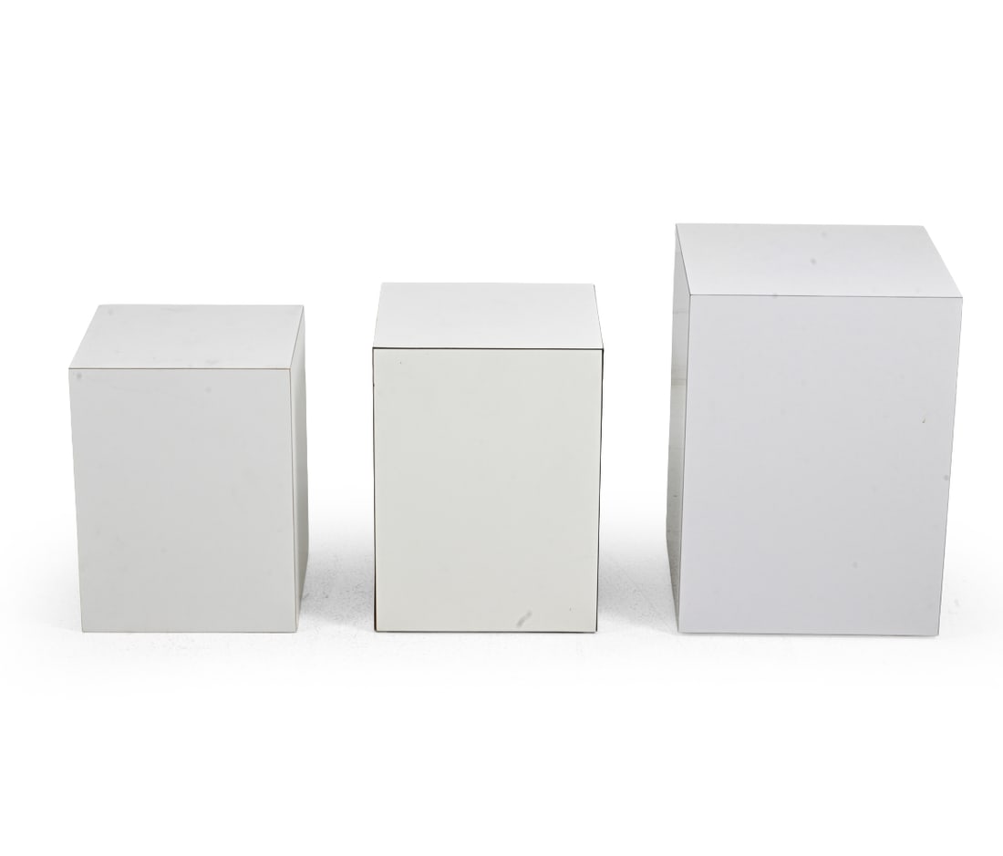 POSTMODERN WHITE LAMINATE PEDESTALS: Set of 3 white laminate display pedestals, each of rectangular column form. Circa, 1970s. Dimensions: H 19.5''x W 14.25''x D 14.25" Condition: Discoloration/staining. Veneer lifting at corners/edges. 