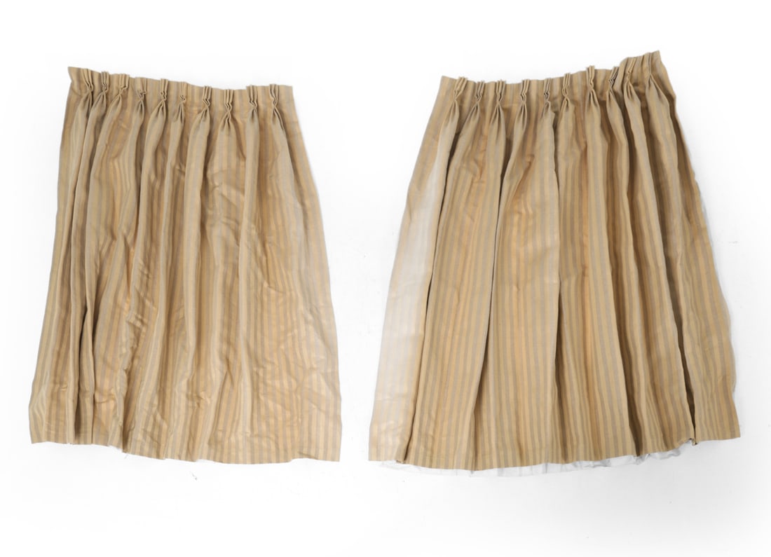 PAIR OF PLEATED STRIPED DRAPES: Cream with grey stripes in woven fabric. Dimensions: L 51" x W 74" Condition: Sun fading to edges. Some stains and light wear. Wear consistent with age and use.