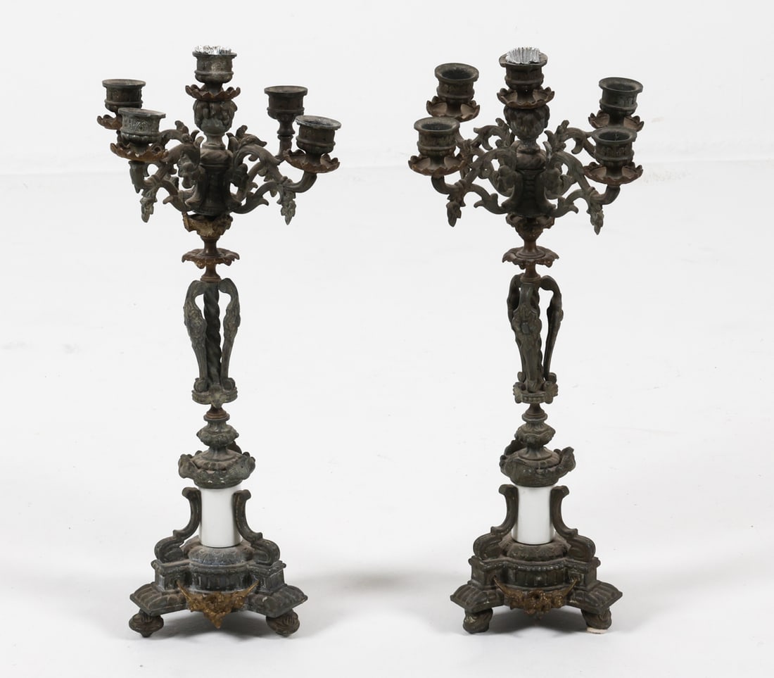 PAIR OF ANTIQUE CANDELABRAS: White metal and porcelain. Dimensions: H 19.75" x Dia. 9". Condition: Minor losses to arms. loss of metal decoration. Feet are bent and askew. Some surface soiling. Wear consistent with age and use.