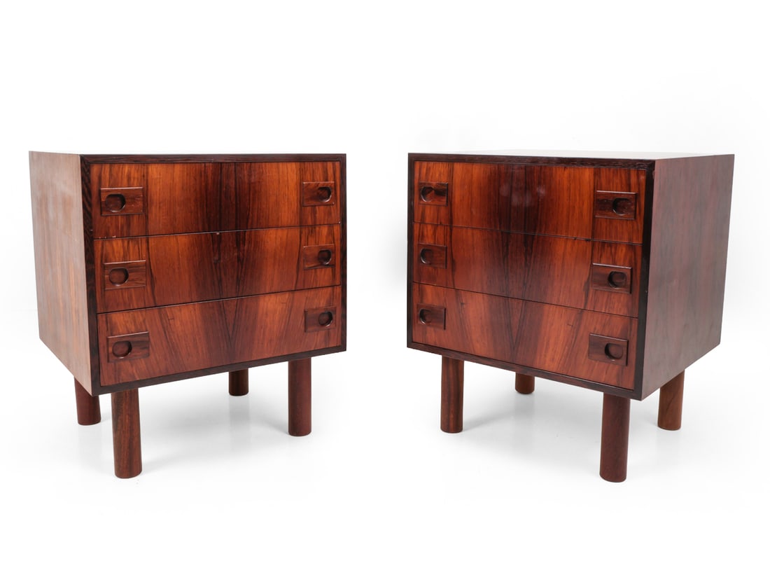 PAIR ATTR. BROUER DANISH ROSEWOOD NIGHTSTANDS: Made in Denmark control stamp on backside. Rosewood with recessed handles and cylindrical legs. Denmark, circa 1960s. Dimensions: H 26" x W 22? x D 20.25? Condition: Sun fading, chips to veneer on dra